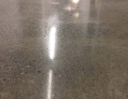 Polished concrete floor reflecting overhead light