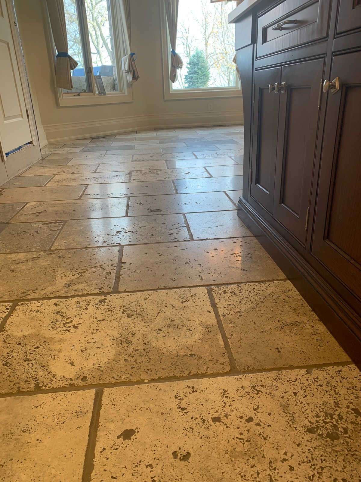 Natural stone floor after surface and grout restoration